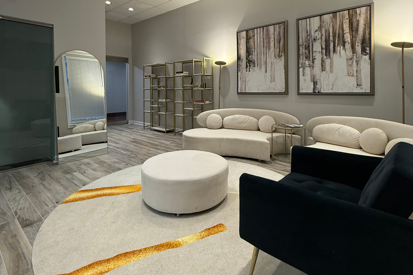 Chicago Medspa reception lounge with cream seating and abstract wall art